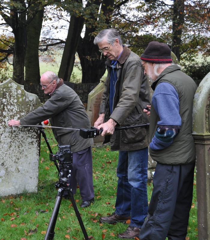 Members of the Embsay with Eastby Research Group conduct RTI photography on a gravestone.